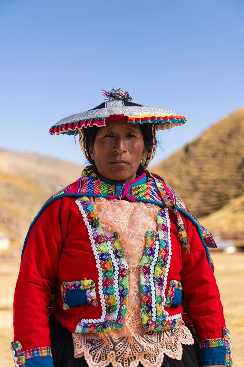 A woman wearing colorful traditional clothing outdoors
